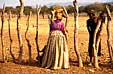 Herrero woman talking to Himba shepherd