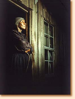 Woman in doorway of shack, Alabama